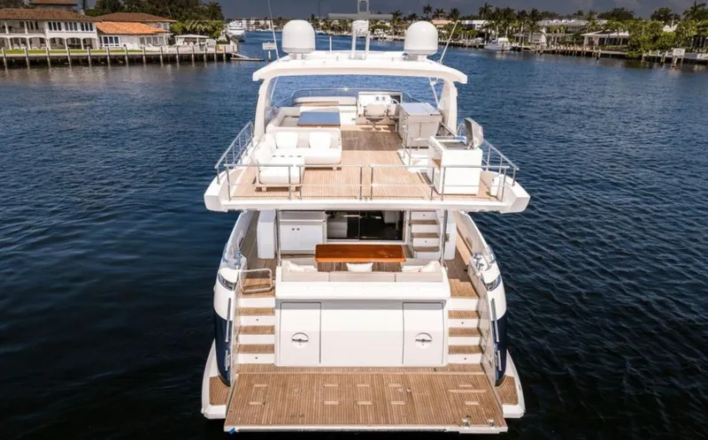 Mancusa Yacht Photos Pics Azimut Fly 72 yacht, 2016 model, docked on a serene waterfront.