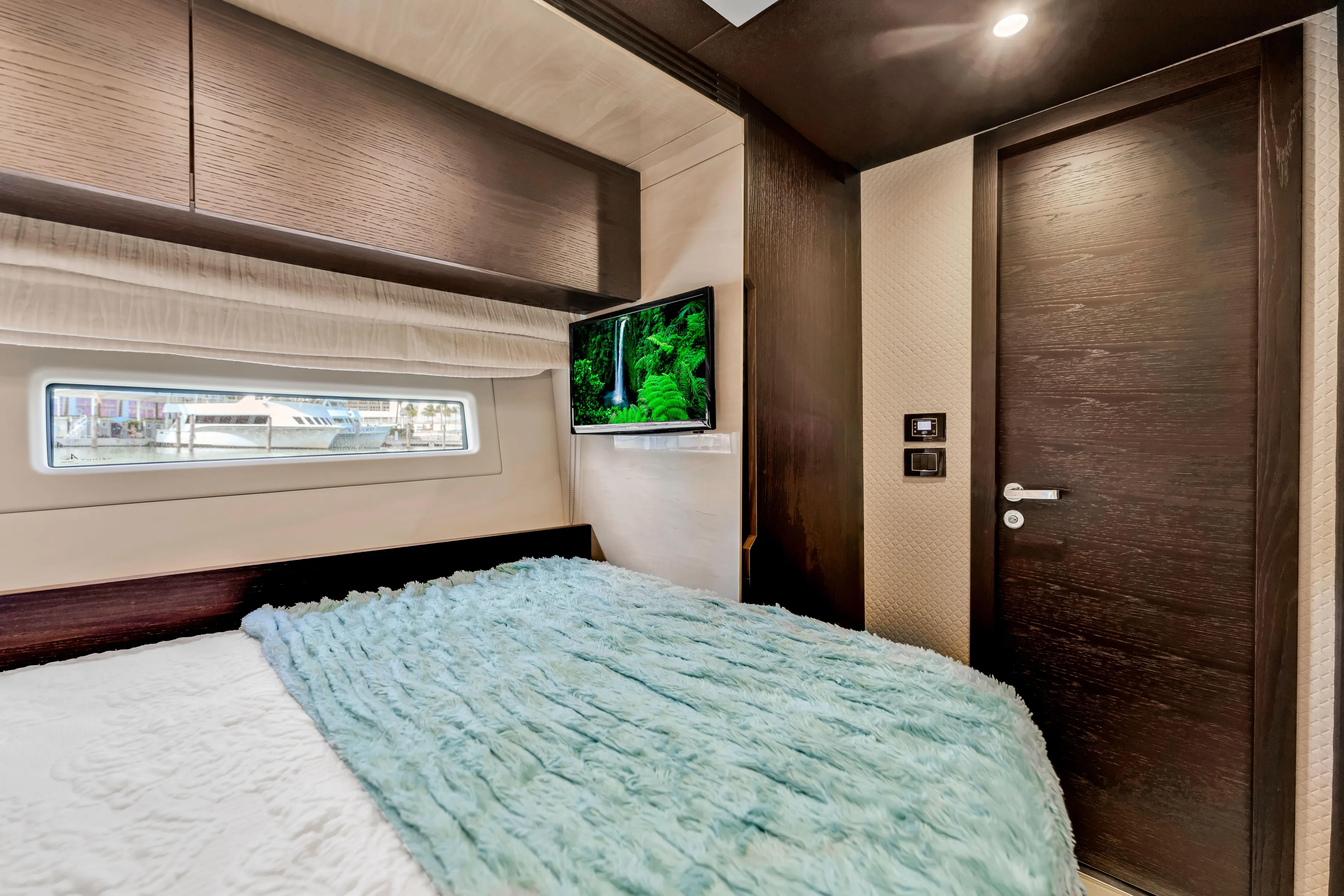 Mancusa Yacht Photos Pics Luxurious bedroom interior of 2016 Azimut Fly 72 yacht with modern decor and window view.