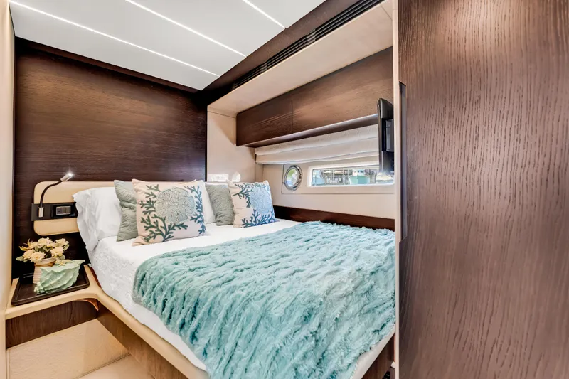 Mancusa Yacht Photos Pics Luxurious bedroom interior of 2016 Azimut Fly 72 yacht with elegant bedding and wood accents.
