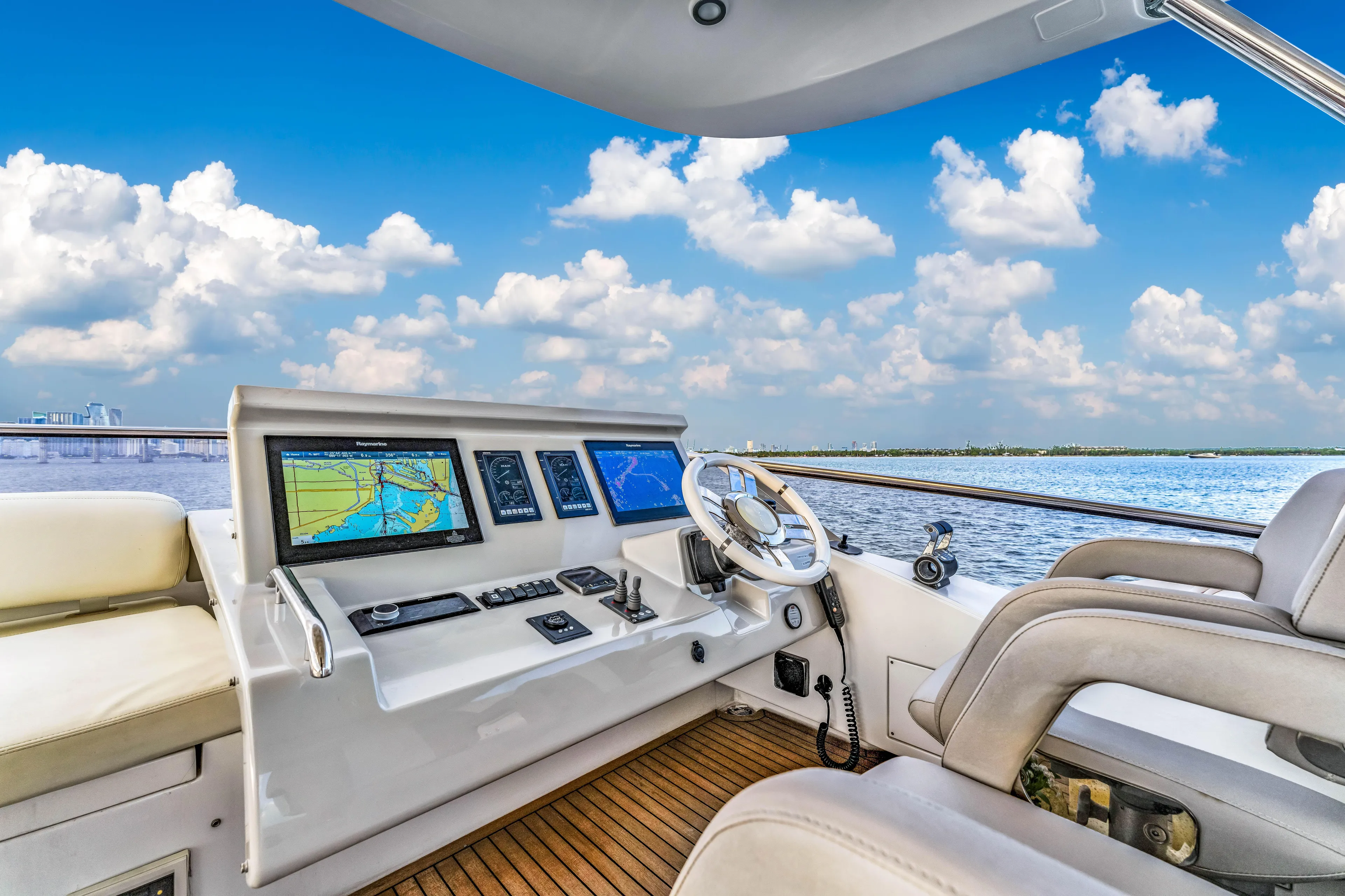 Mancusa Yacht Photos Pics Luxurious 2016 Azimut Fly 72 yacht cockpit with navigation screens, steering wheel, and ocean view.