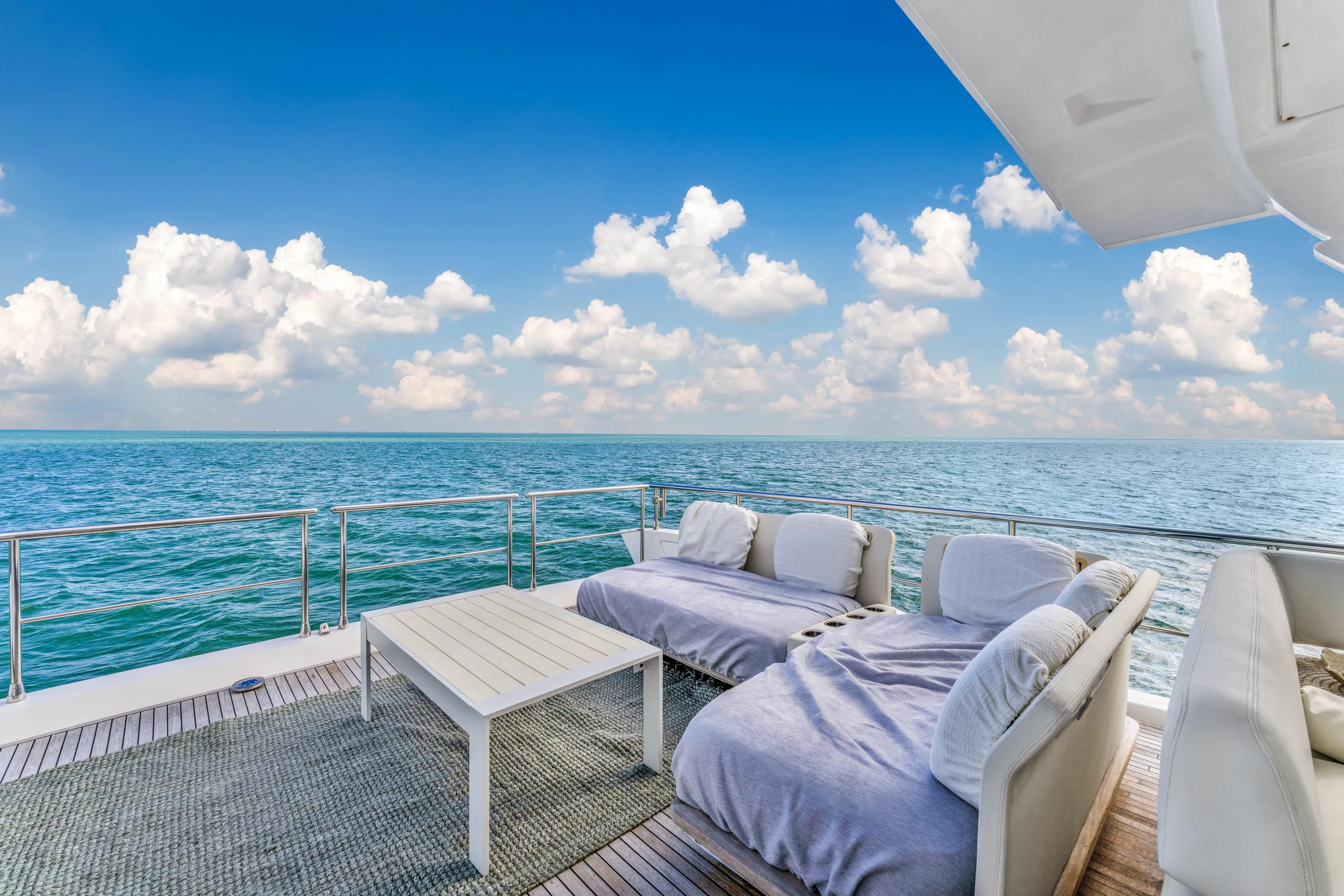 Mancusa Yacht Photos Pics Luxurious Azimut Fly 72 yacht deck with ocean view, featuring comfortable seating, 2016 model.