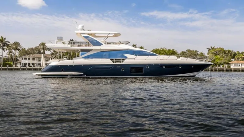 Mancusa Yacht Photos Pics 2016 Azimut Fly 72 yacht on calm water, with luxury waterfront homes in the background.