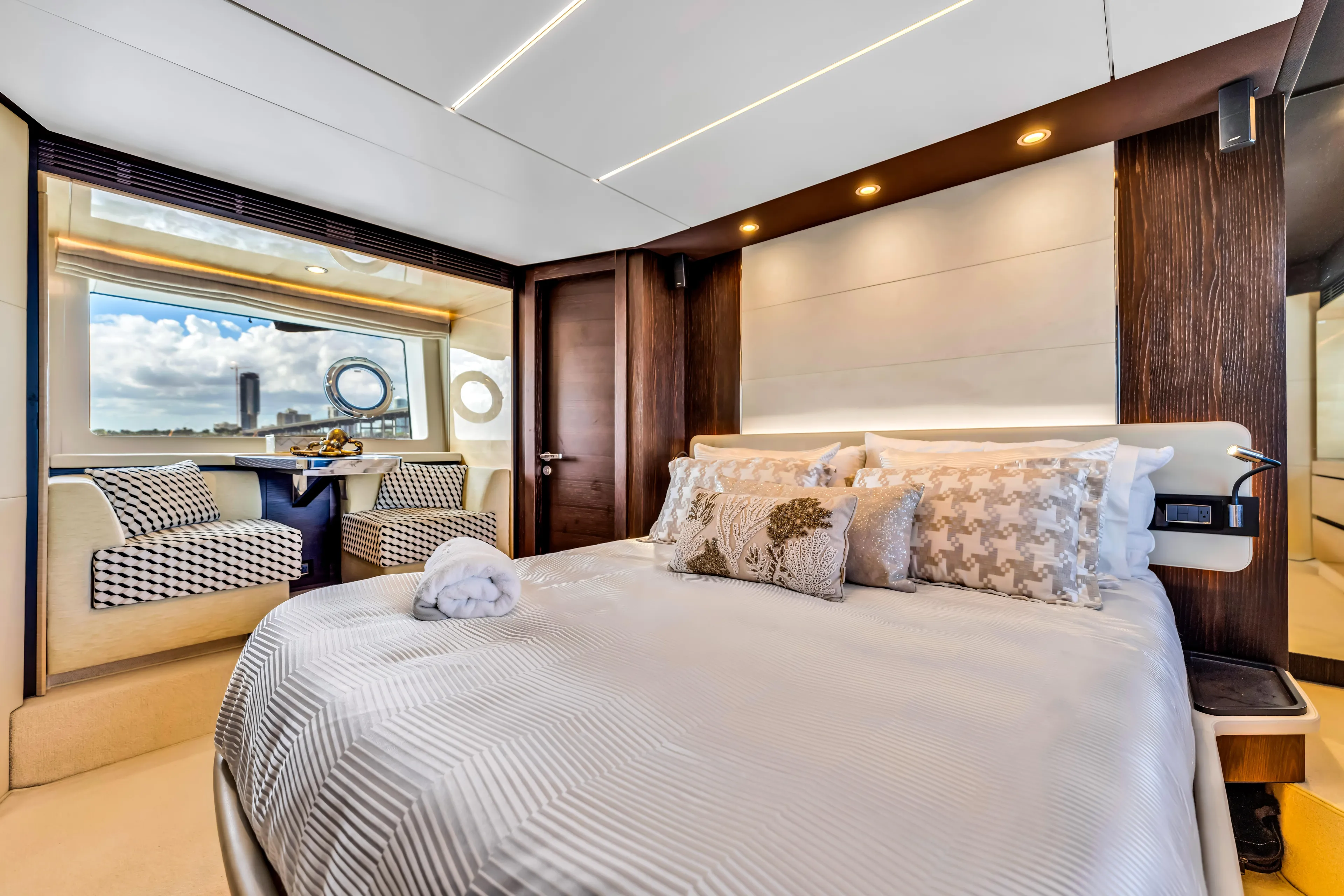 Mancusa Yacht Photos Pics Luxurious bedroom interior of 2016 Azimut Fly 72 yacht with elegant decor and large window view.