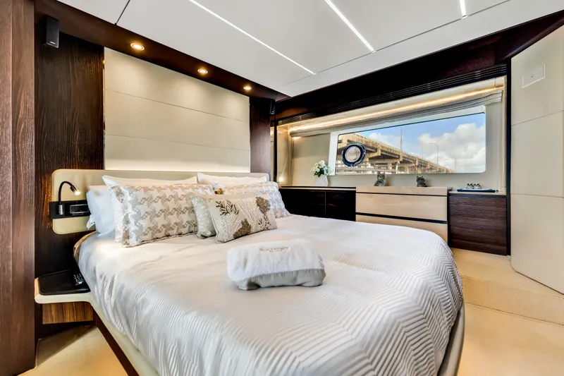 Mancusa Yacht Photos Pics Luxurious bedroom interior of 2016 Azimut Fly 72 yacht with elegant decor and large window view.