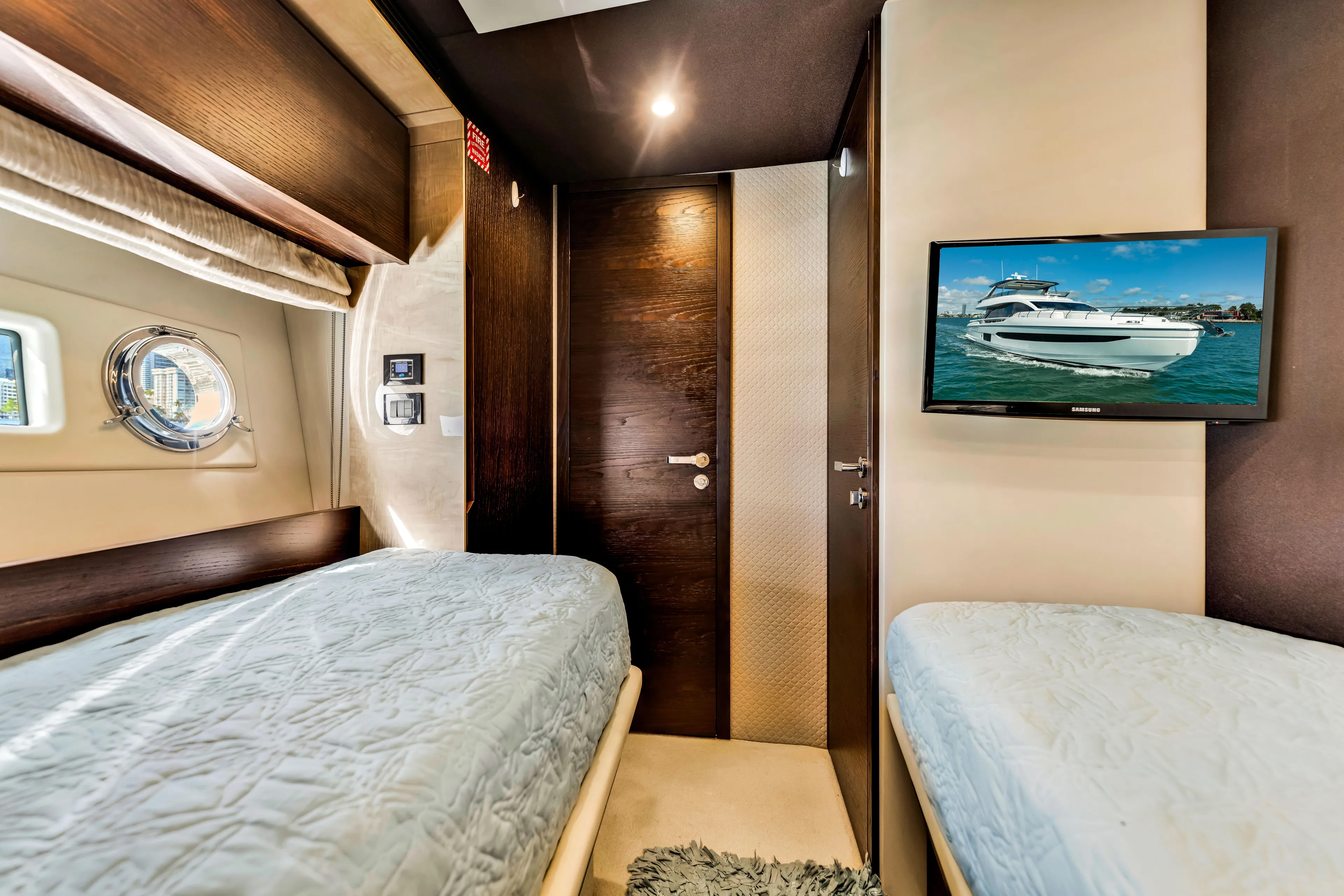 Mancusa Yacht Photos Pics Interior of 2016 Azimut Fly 72 yacht cabin with twin beds and wall-mounted TV.