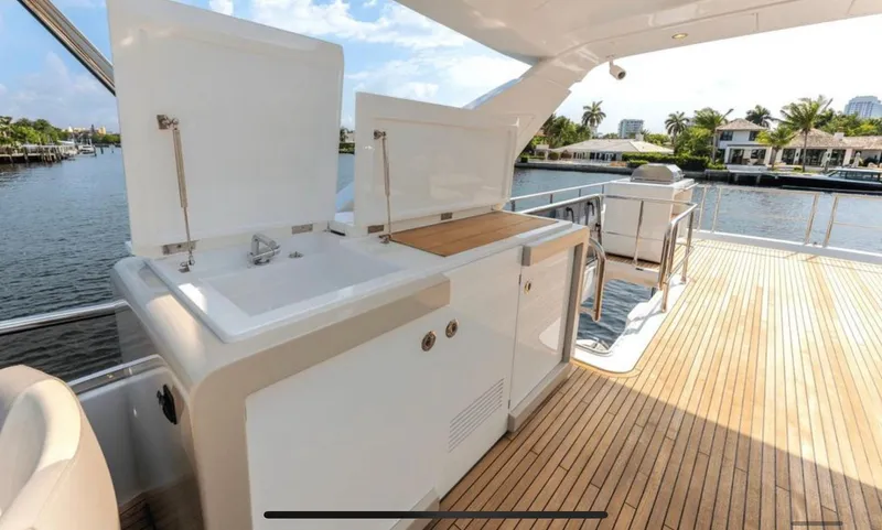 Mancusa Yacht Photos Pics Azimut Fly 72 yacht deck with sink and storage, 2016 model, overlooking waterfront.