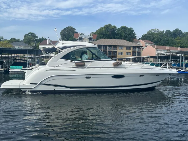  Yacht Photos Pics 2014 Formula 45 Yacht cruising on a calm waterfront with buildings in the background.