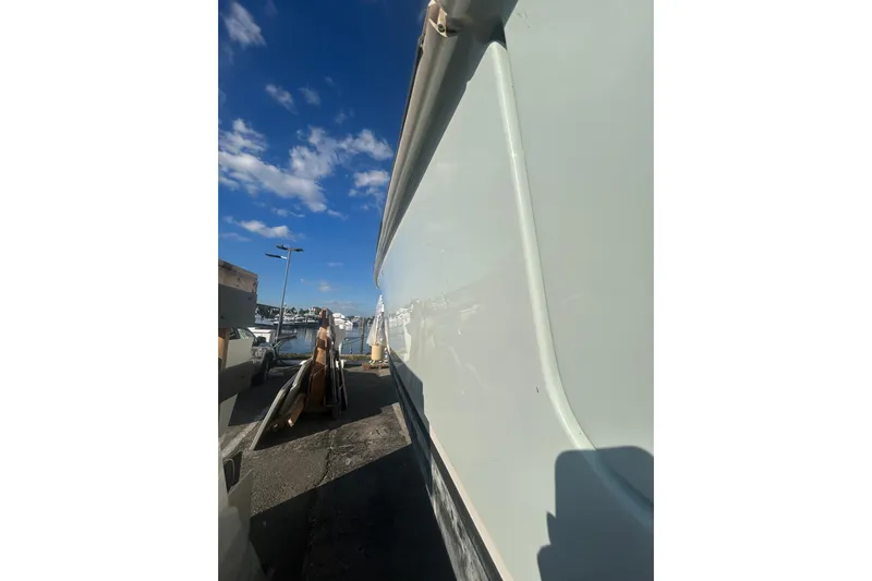 Tt Virtue Yacht Photos Pics Side view of a 2012 Boston Whaler 370 Outrage boat under a clear blue sky.