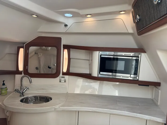 V5 Yacht Photos Pics 2019 Grady-White Freedom 375 boat interior with sink, microwave, and storage.