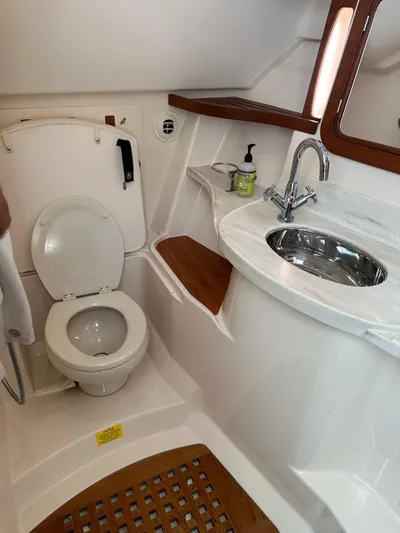 V5 Yacht Photos Pics 2019 Grady-White Freedom 375 boat bathroom with toilet, sink, and wooden accents.