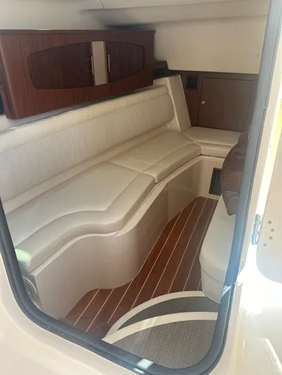 V5 Yacht Photos Pics 2019 Grady-White Freedom 375 cabin interior with cushioned seating and wood accents.