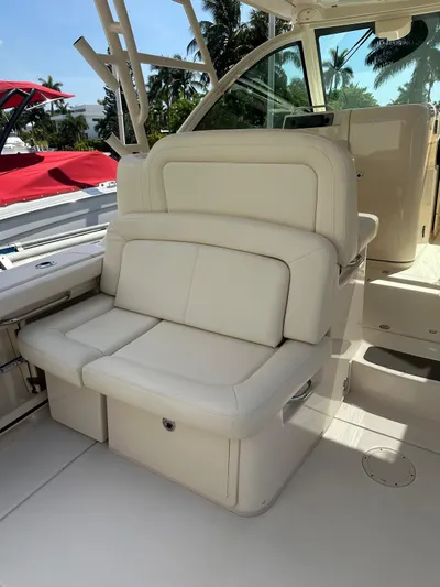 V5 Yacht Photos Pics 2019 Grady-White Freedom 375 boat interior with white seating and tropical backdrop.