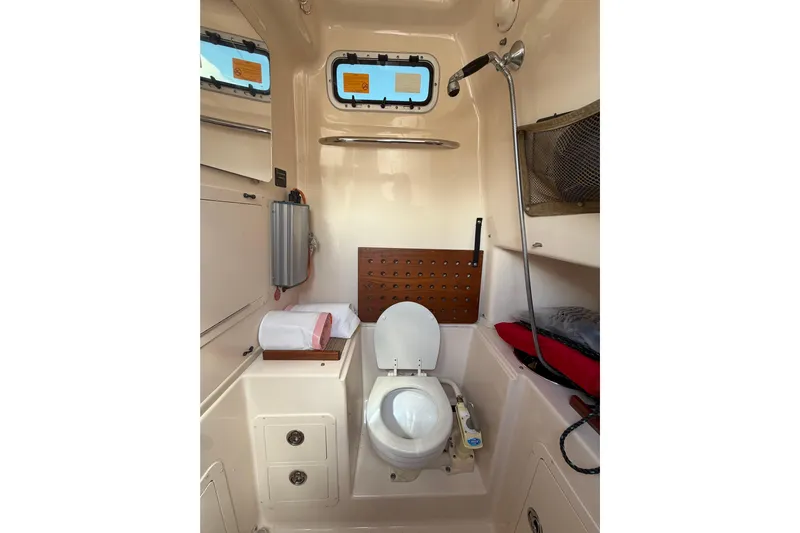  Yacht Photos Pics 2007 Grady-White Bimini 306 boat bathroom with toilet, shower, and storage.