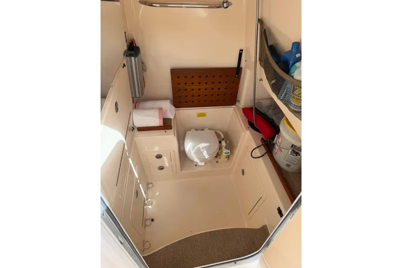  Yacht Photos Pics 2007 Grady-White Bimini 306 boat interior with storage and marine toilet.