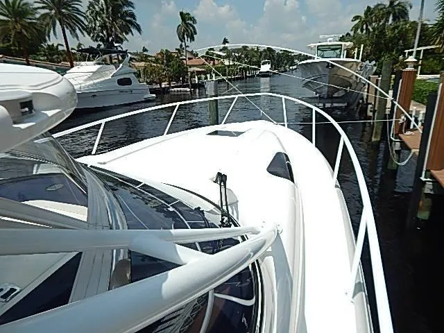 Intrepidation Yacht Photos Pics 2009 Intrepid 430 Sport Yacht docked in a scenic marina with palm trees.