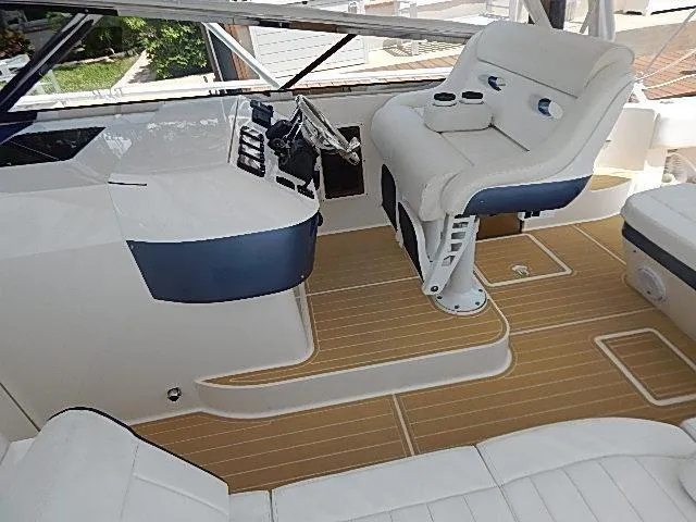 Intrepidation Yacht Photos Pics 2009 Intrepid 430 Sport Yacht cockpit with white seating and wood-style flooring.