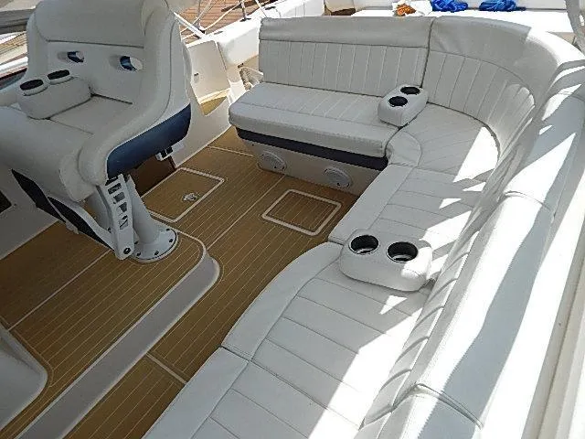 Intrepidation Yacht Photos Pics Luxurious seating on 2009 Intrepid 430 Sport Yacht with white upholstery and cup holders.