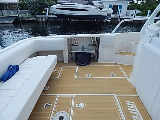 Intrepidation Yacht Photos Pics 2009 Intrepid 430 Sport Yacht deck with seating, docked near waterfront homes.