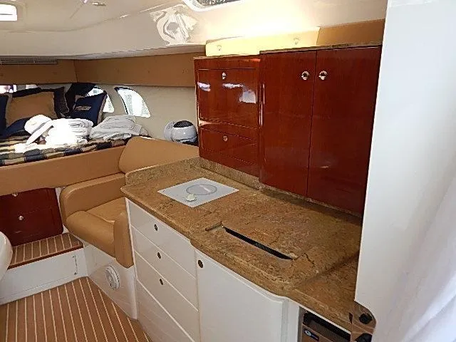 Intrepidation Yacht Photos Pics Interior of 2009 Intrepid 430 Sport Yacht with wood cabinets and beige seating.