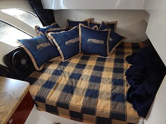 Intrepidation Yacht Photos Pics Cozy cabin interior of 2009 Intrepid 430 Sport Yacht with checkered bedding and branded pillows.