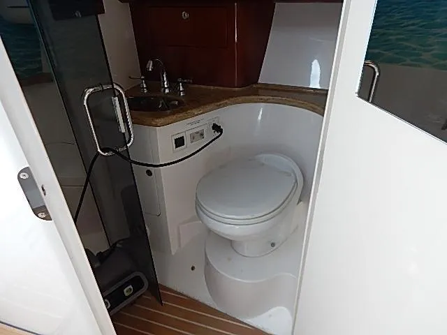 Intrepidation Yacht Photos Pics 2009 Intrepid 430 Sport Yacht bathroom with toilet, sink, and wooden flooring.
