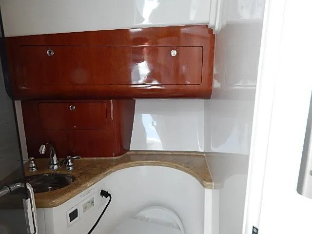Intrepidation Yacht Photos Pics 2009 Intrepid 430 Sport Yacht bathroom with wooden cabinets and compact sink.