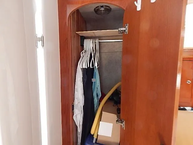 Intrepidation Yacht Photos Pics Wooden closet interior on a 2009 Intrepid 430 Sport Yacht, with hangers and storage items.