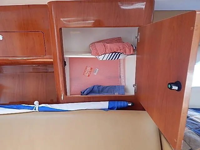 Intrepidation Yacht Photos Pics Wooden cabinet interior on 2009 Intrepid 430 Sport Yacht with folded clothes.
