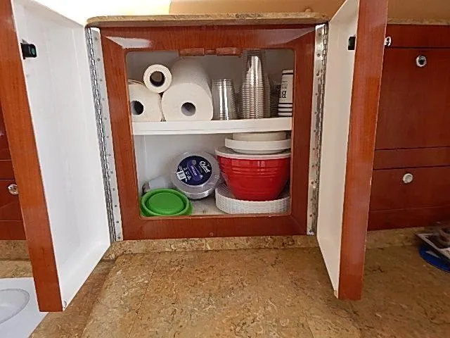 Intrepidation Yacht Photos Pics Cabinet storage on 2009 Intrepid 430 Sport Yacht with paper towels and kitchen supplies.