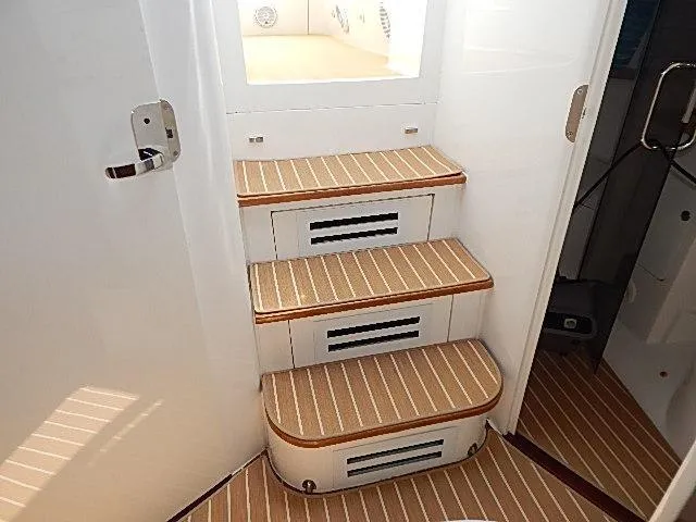 Intrepidation Yacht Photos Pics Staircase inside 2009 Intrepid 430 Sport Yacht with striped carpet and white walls.