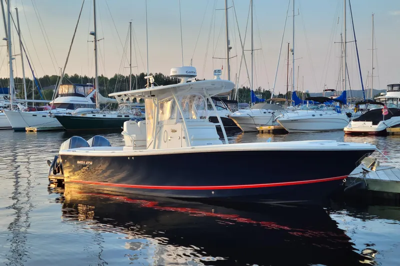  Yacht Photos Pics 2015 Regulator 28 Forward Seating boat docked in a marina at sunset.