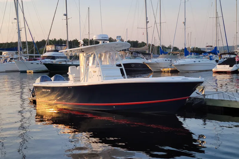  Yacht Photos Pics 2015 Regulator 28 Forward Seating boat docked at marina during sunset.