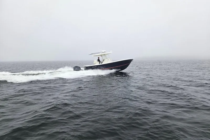  Yacht Photos Pics 2015 Regulator 28 Forward Seating boat cruising on open water.