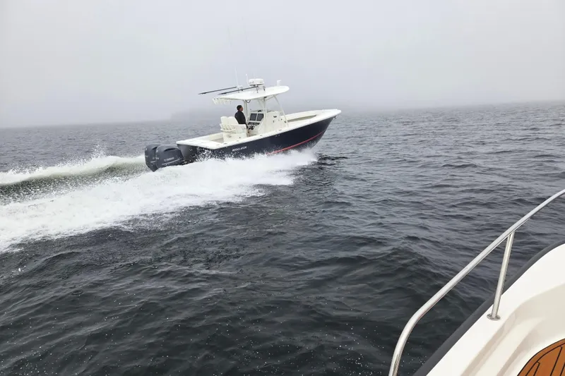  Yacht Photos Pics 2015 Regulator 28 Forward Seating boat cruising on open water.