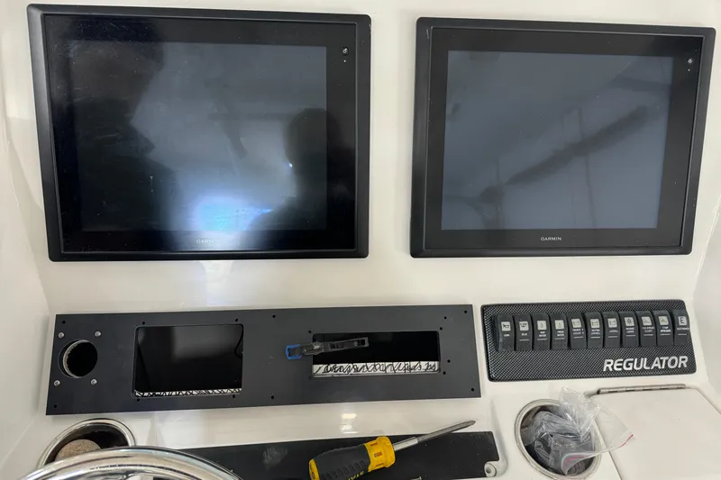  Yacht Photos Pics Control panel of a 2015 Regulator 28 Forward Seating boat with Garmin displays.