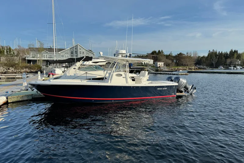  Yacht Photos Pics 2015 Regulator 28 Forward Seating boat docked at a marina, calm water, clear sky.