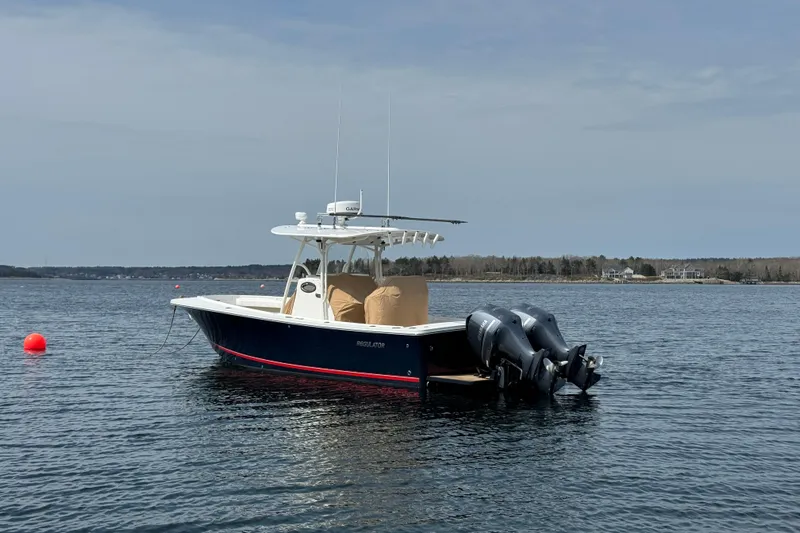  Yacht Photos Pics 2015 Regulator 28 Forward Seating boat on calm water with dual engines.