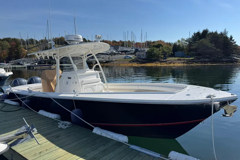  Yacht Photos Pics 2015 Regulator 28 Forward Seating boat docked by a scenic marina.