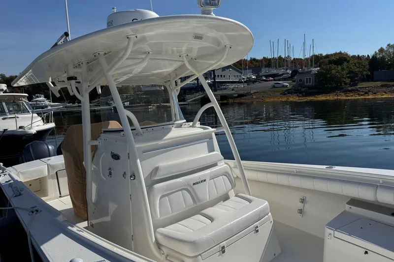  Yacht Photos Pics 2015 Regulator 28 Forward Seating boat docked in a marina, showcasing sleek design and spacious seating.