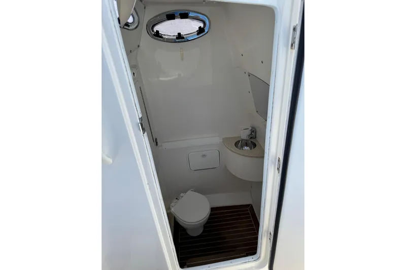  Yacht Photos Pics 2015 Regulator 28 Forward Seating boat interior bathroom with toilet and sink.