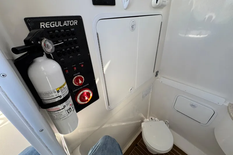  Yacht Photos Pics 2015 Regulator 28 Forward Seating interior with control panel and fire extinguisher.
