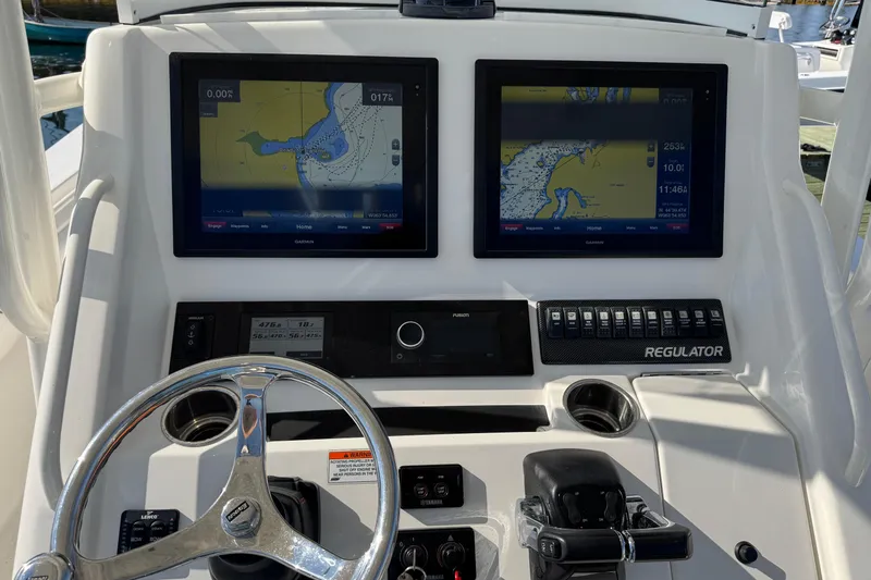  Yacht Photos Pics 2015 Regulator 28 Forward Seating boat dashboard with dual navigation screens and controls.