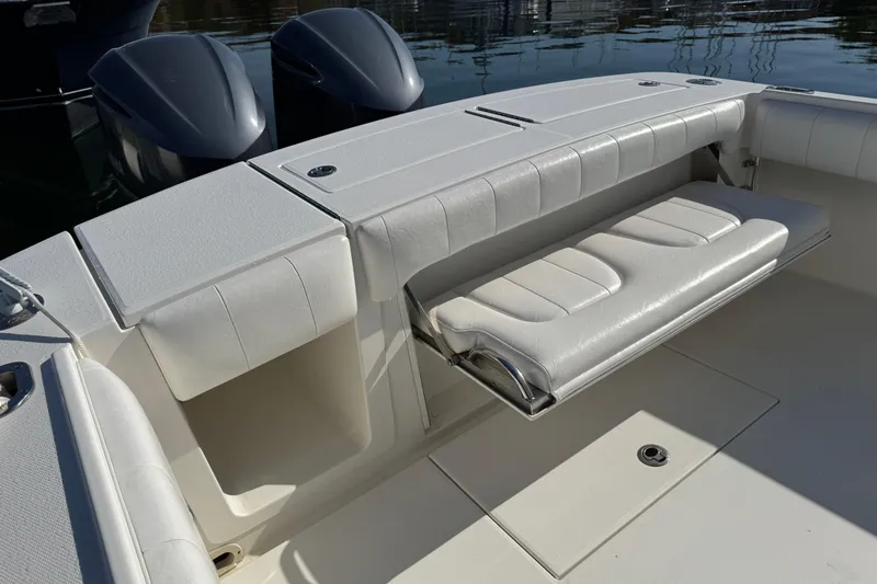  Yacht Photos Pics 2015 Regulator 28 Forward Seating boat with white cushioned seats and storage compartments.
