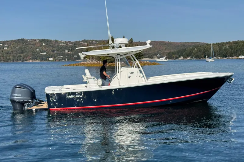  Yacht Photos Pics 2015 Regulator 28 Forward Seating boat on calm water with scenic background.