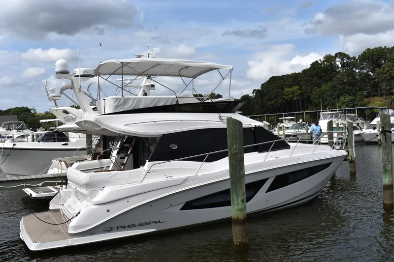 Me Yacht Photos Pics 2021 Regal 42 Fly yacht docked in marina, surrounded by other boats.