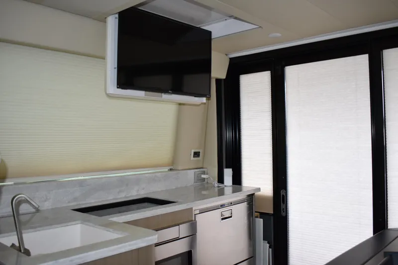 Me Yacht Photos Pics Modern kitchen interior of 2021 Regal 42 Fly yacht with TV and appliances.