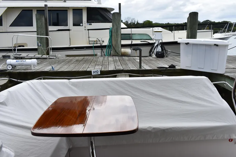 Me Yacht Photos Pics Regal 42 Fly 2021 yacht docked, featuring a polished wooden table on deck.