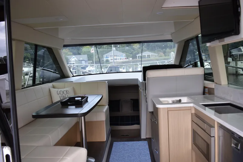 Me Yacht Photos Pics Luxurious interior of 2021 Regal 42 Fly yacht with modern kitchen and seating area.