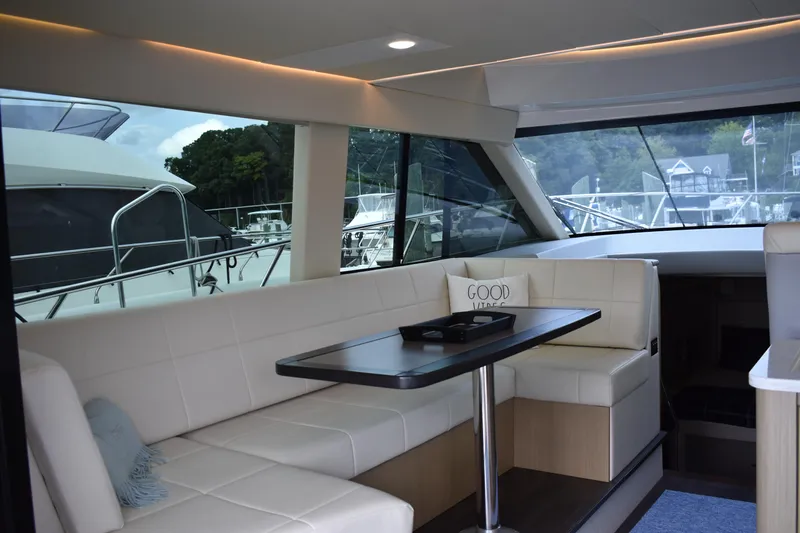 Me Yacht Photos Pics Luxurious interior of 2021 Regal 42 Fly yacht with elegant seating and table.