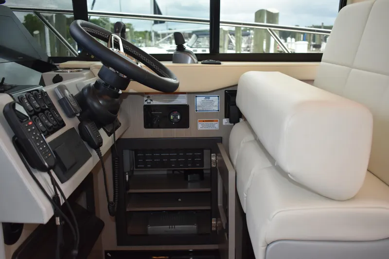 Me Yacht Photos Pics 2021 Regal 42 Fly yacht interior with steering wheel and white seating.